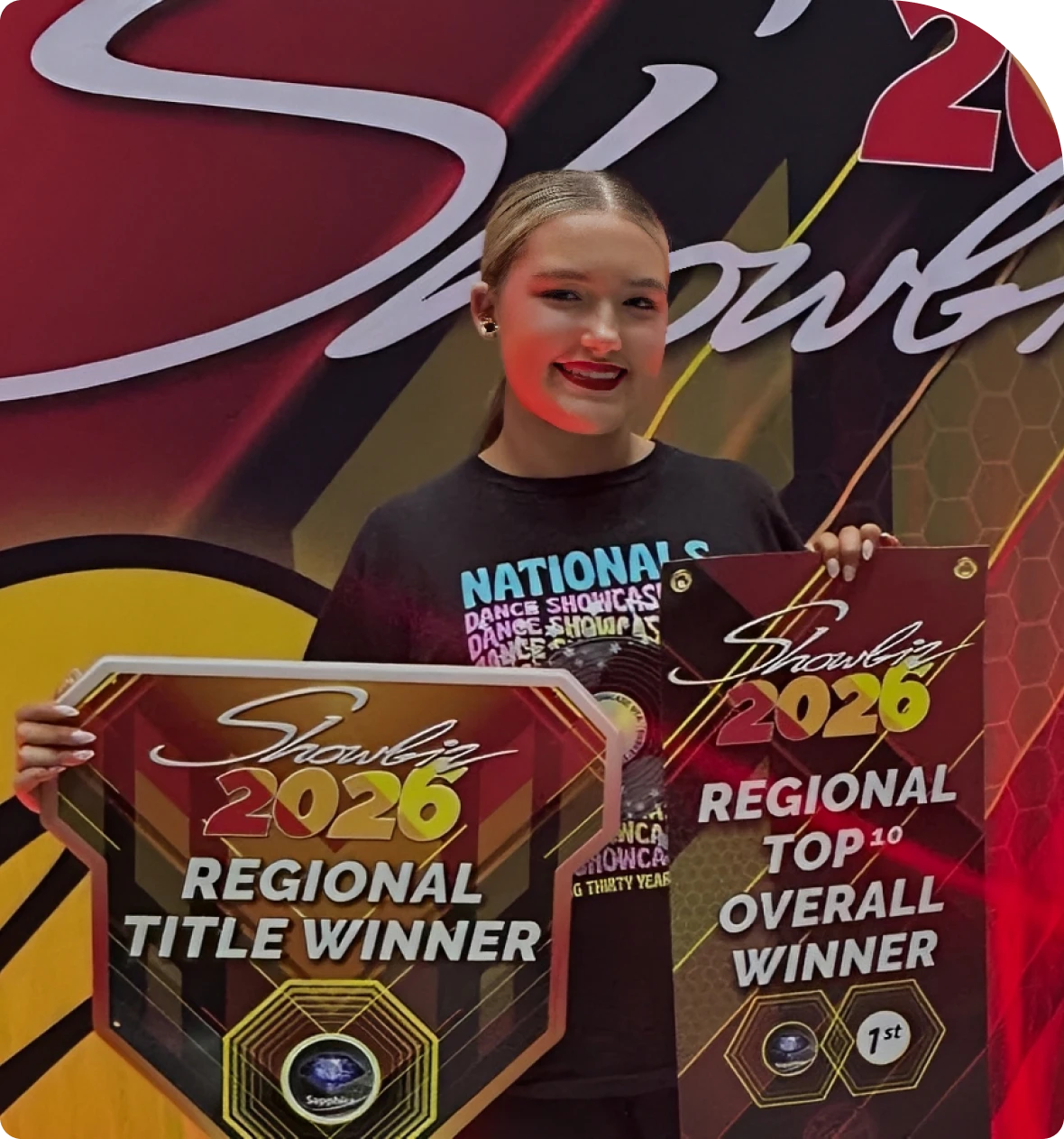 Smiling contestant with award placards