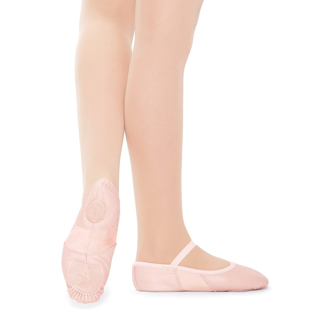 Close-up of feet wearing pink ballet slippers.