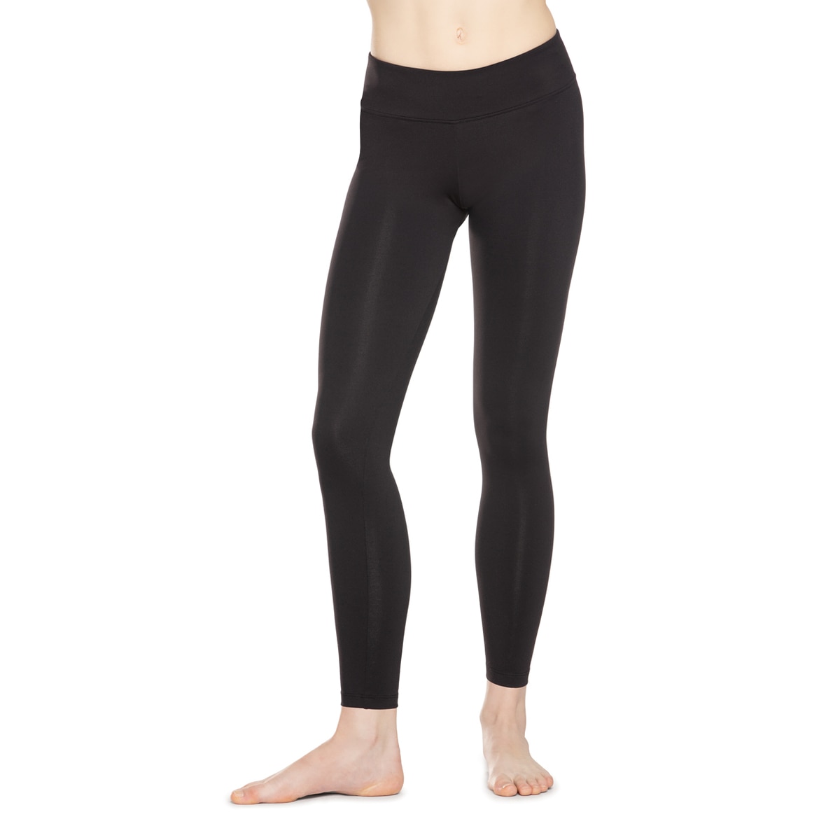 A person wearing black leggings standing barefoot.
