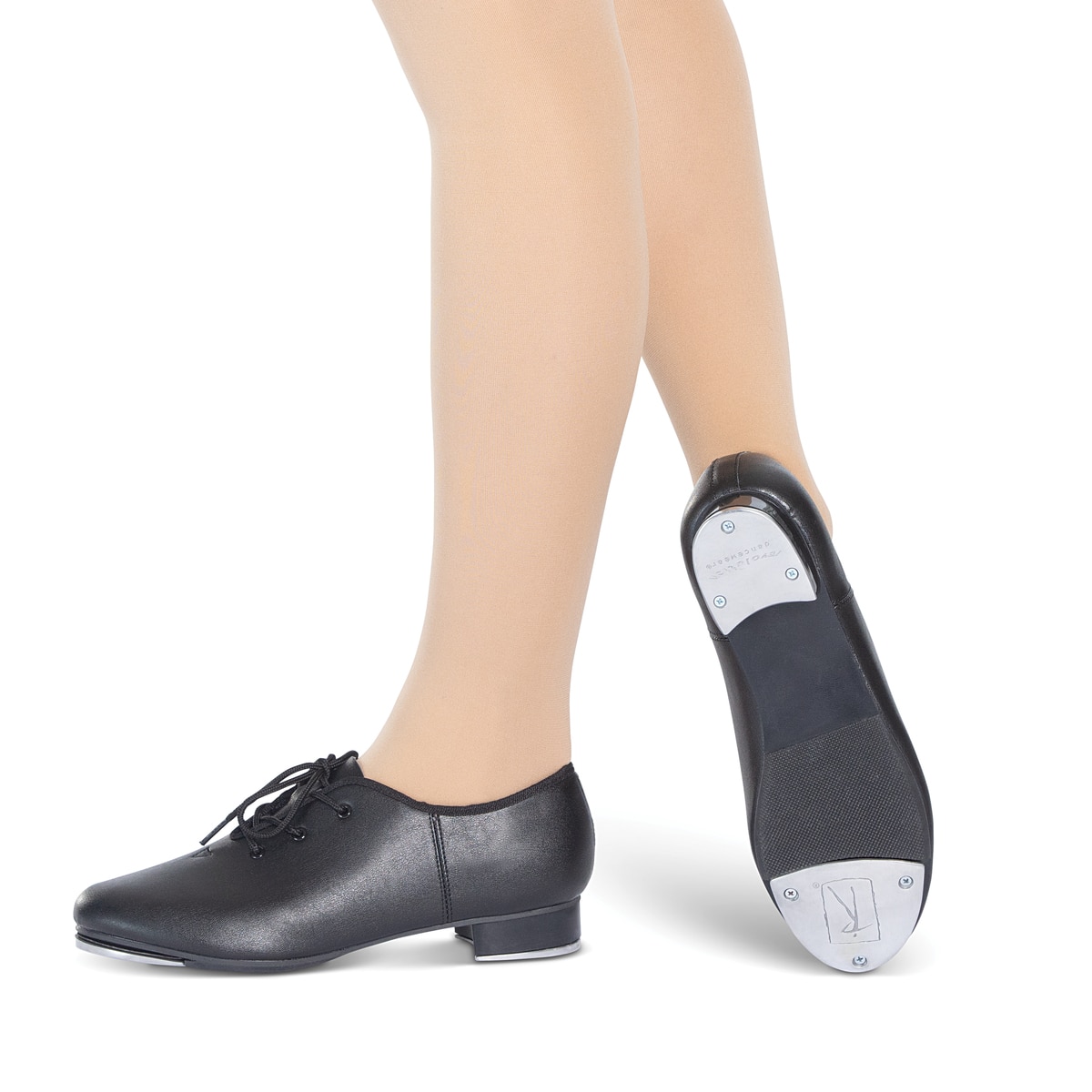 Person wearing black tap shoes and beige tights.