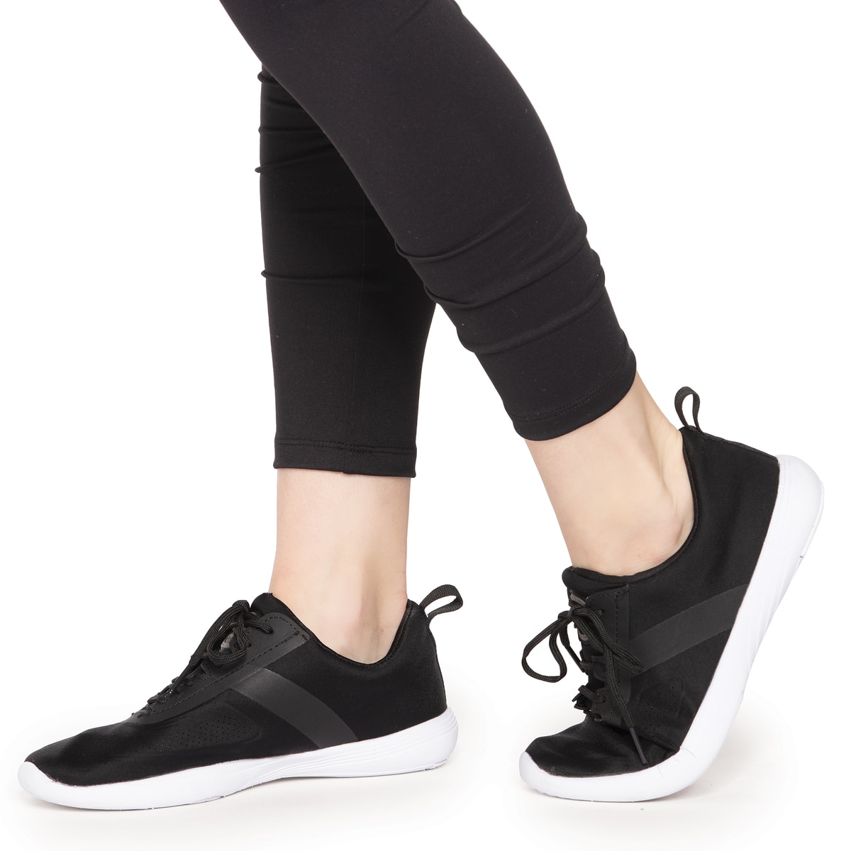 Person wearing black athletic shoes and black leggings.