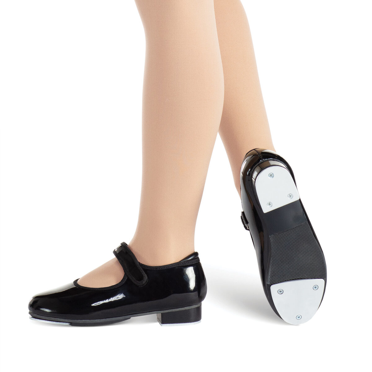 Black tap shoes worn on feet with one shoe showing taps.