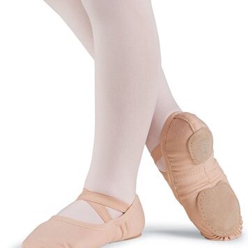 Ballet dancer's feet in pink ballet slippers and tights.