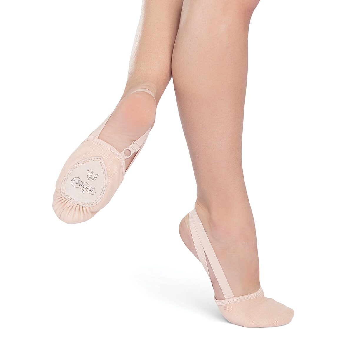 Legs wearing light pink ballet shoes with a suede sole.