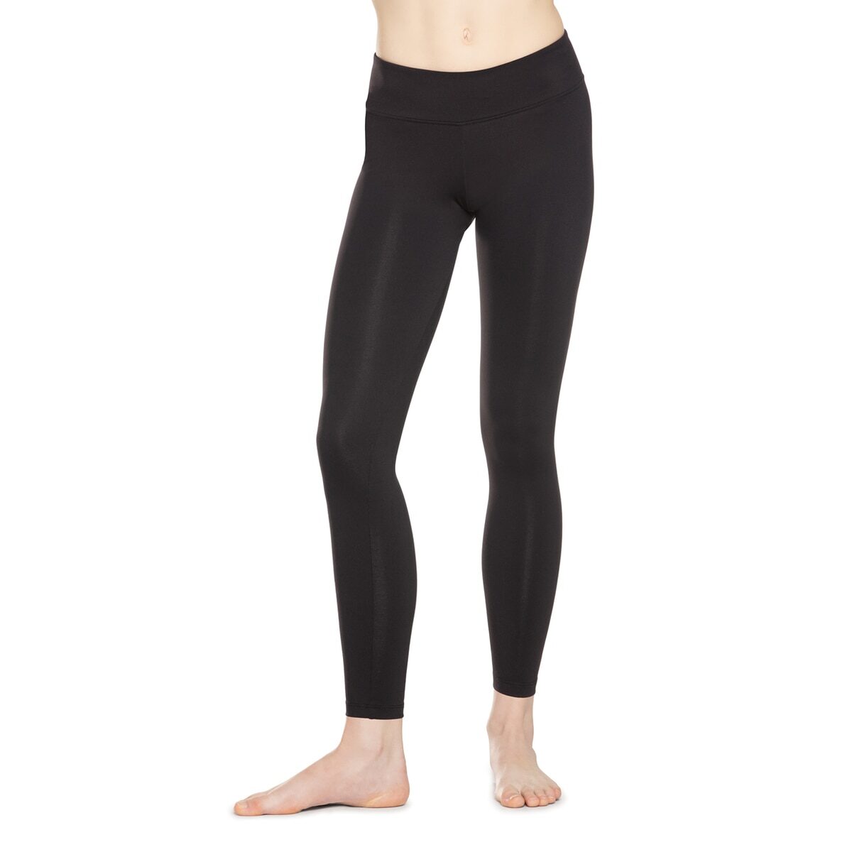 A person wearing black leggings standing barefoot.